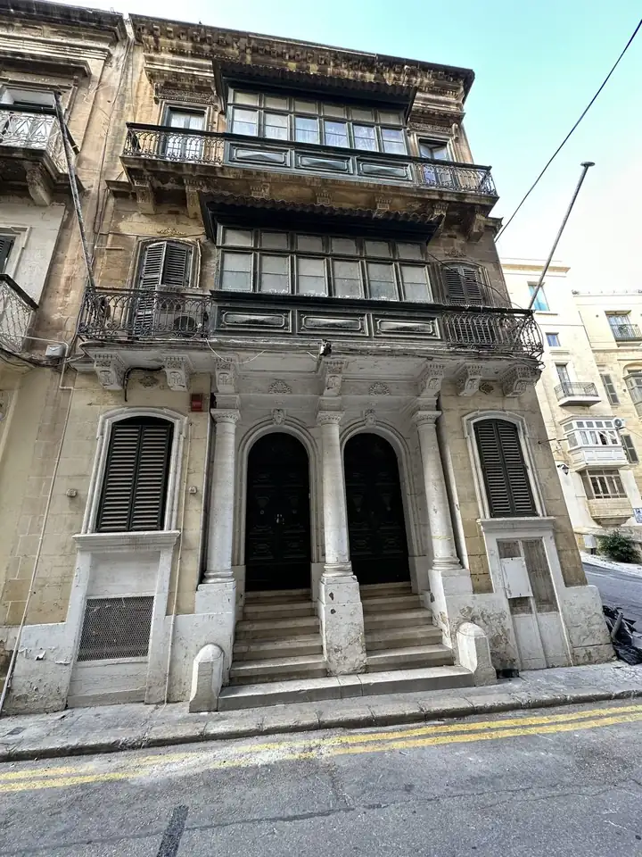 Stadthaus in Valletta mit zwei übereinanderliegenden Balkonen und zwei Rundbogentüren